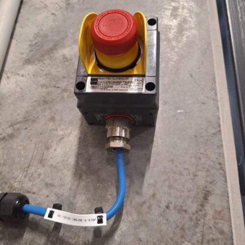 Red and yellow emergency stop button with blue wire in cold storage — MECS hazardous certification project for safety review