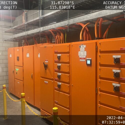 A row of orange electrical cabinets at Coles facility during switchboard replacement by an industrial electrical company in Perth