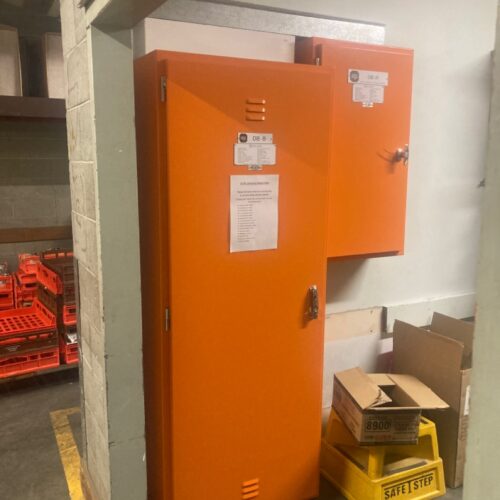 Orange electrical cabinets at Coles facility during switchboard replacement by an industrial electrical company in Perth