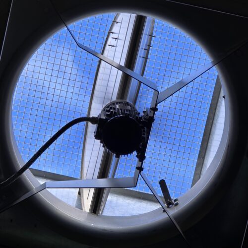 MECS hazardous certification project shows circular window with metal pole and fan for airflow and lighting in Perth Cold Storage Plant Room