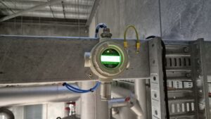 A green digital thermometer is secured to a metal pipe in a Plant Room Perth Cold Storage Facility in compliance with AS/NZS 60079