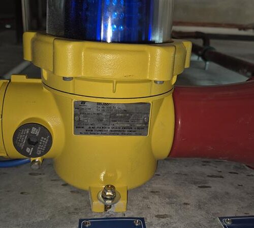 Yellow and red fire alarm in Perth cold storage plant room, part of MECS hazardous certification ensuring safety compliance