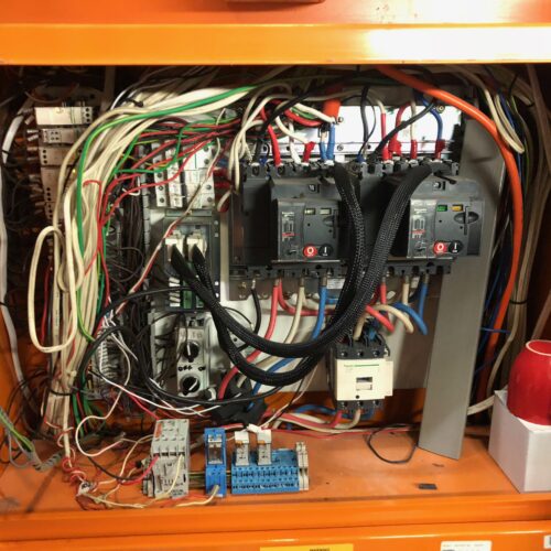 Electrical switchboard in orange box prepared for replacement at Coles store project by an industrial electrical company