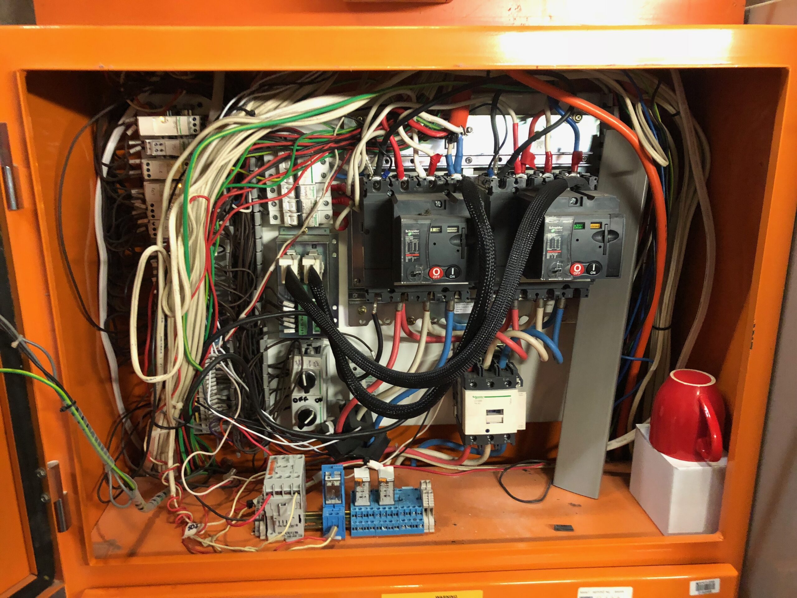 Electrical switchboard in orange box prepared for replacement at Coles store project by an industrial electrical company