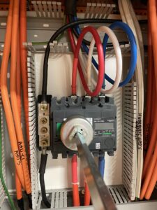 Close-up view of a switch and wires inside MSSB Swap building cabinet showing electrical components with MECS Power Monitor
