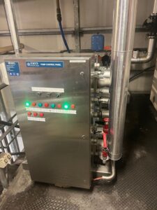 Large industrial water heater with green indicator light within a Refrigeration Services Switchboard for a processing factory Power Monitoring setup