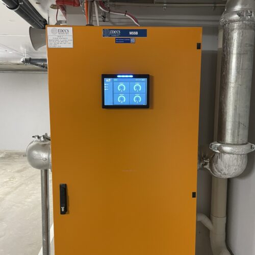 An orange electrical control panel installed at Rivean Apartments for carbon monoxide safety control