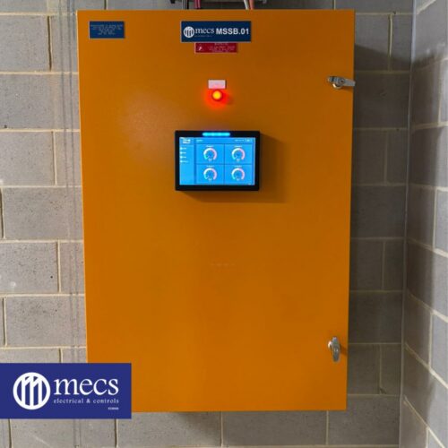 An orange electrical control panel box containing various electronic components for mechanical electrical, and controls installation at St Ives