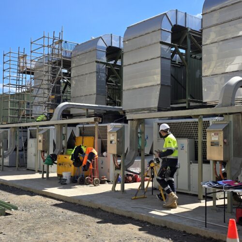 Electrical mechanics installing HVAC control system at Boddington Gold Mine for industrial climate control automation and site operations