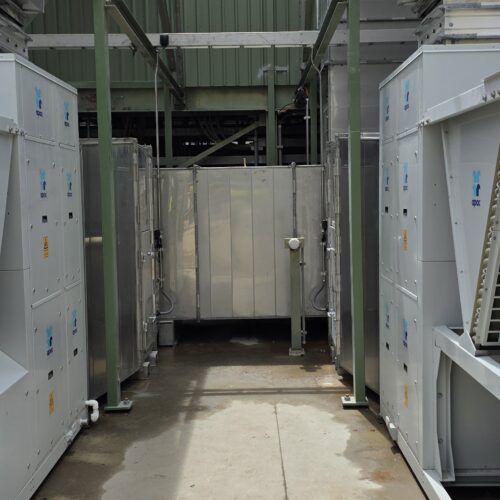 Air conditioning units at Boddington Gold Mine site with HVAC control system near large metal door in industrial setting