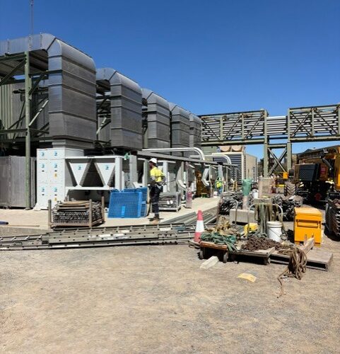 Electrical mechanic installing HVAC control system at Boddington Gold Mine ensuring efficient climate control for industrial structure