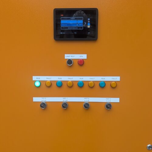 Orange electrical control panel with buttons and wiring installed by MECS electrical mechanic as part of industrial electrical control panel system