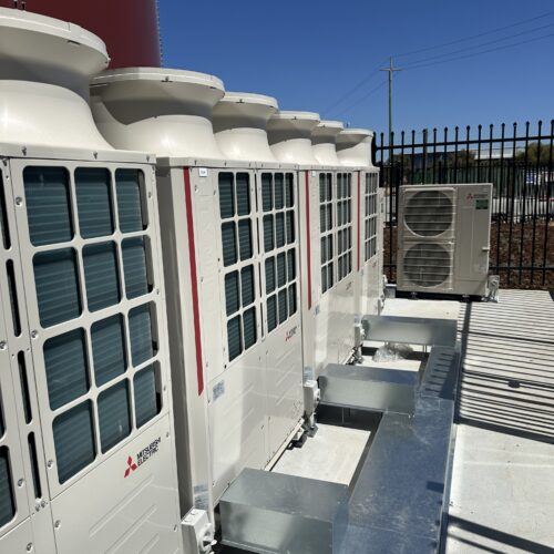 Rooftop air conditioning units integrated with HVAC control system managing temperature and airflow
