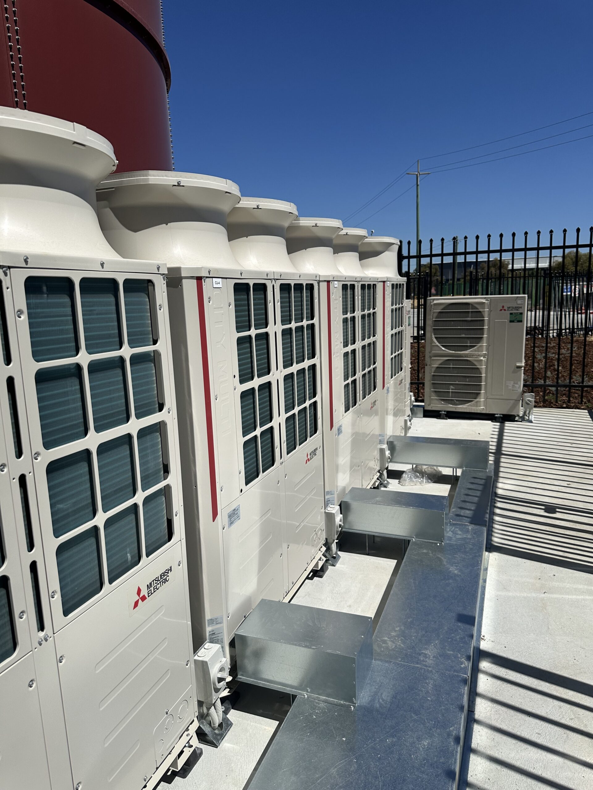 Rooftop air conditioning units integrated with HVAC control system managing temperature and airflow
