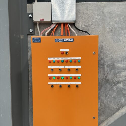 Wall-mounted electrical control panel with various wires, installed by electrical mechanic for industrial control operations
