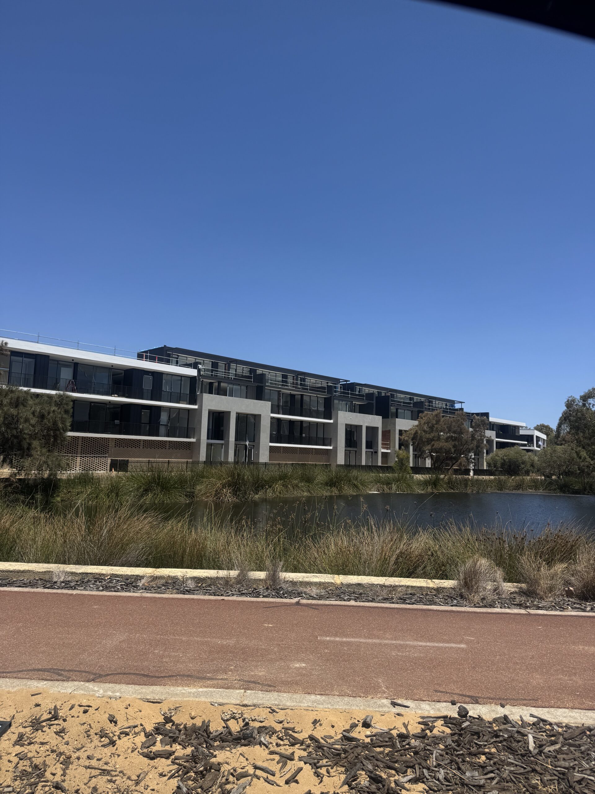 Cygnus Parade Apartments beside the pond with HVAC control system installed by MECS electrical mechanics for building climate management and efficiency